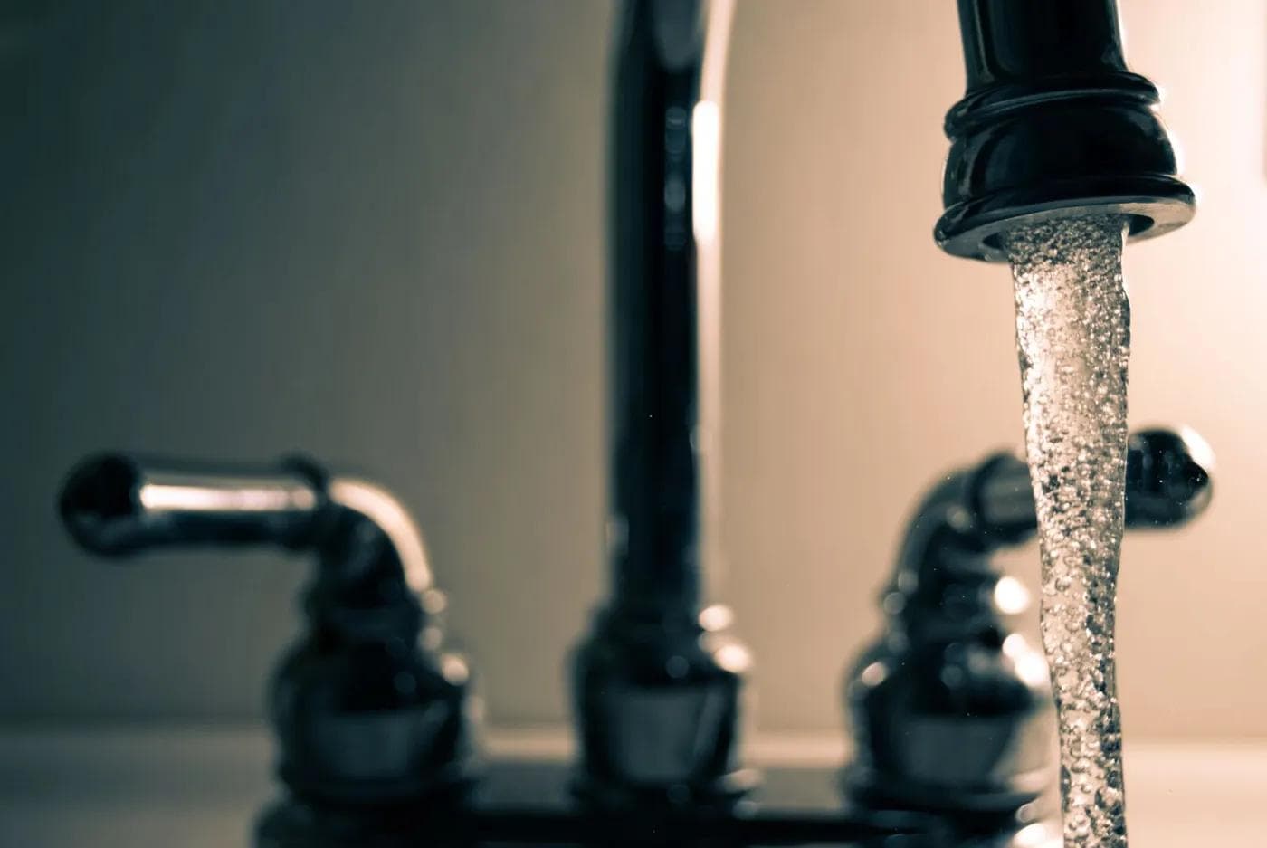 Water running from a stainless kitchen faucet